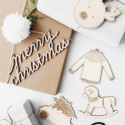 Decorações de Natal em madeira e presentes embrulhados com texto 'merry christmas'