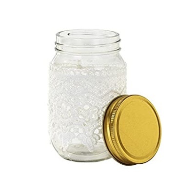 Frasco de vidro com tampa dourada e bolhas de sabão