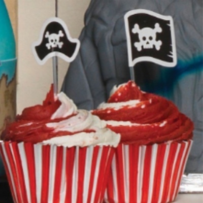 Dois cupcakes vermelhos e brancos com bandeiras de caveira de pirata