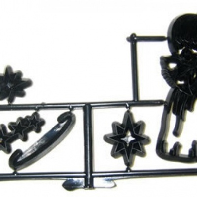 Peças plásticas pretas para montagem em moldura com formas de estrelas, flor, arco e anjo