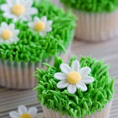 Cupcake com cobertura verde e flor decorativa