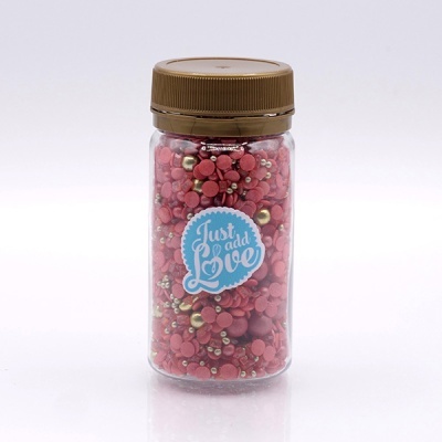 Frasco transparente com confeitos decorativos vermelhos e dourados