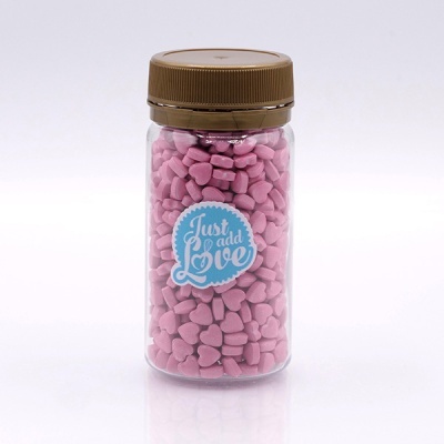 Frasco transparente com partículas rosa e etiqueta Just add Love