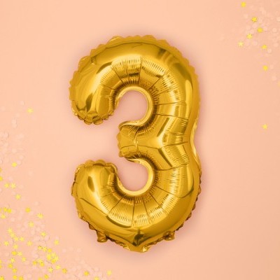 Balão dourado número 3 em fundo rosa com estrelas amarelas