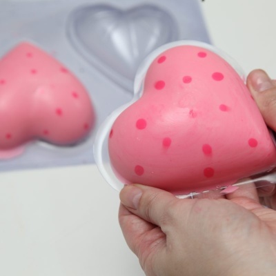 Moldes em forma de coração cor-de-rosa com pontos vermelhos