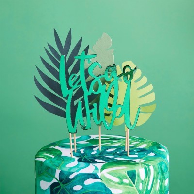 Bolo decorado com padrão de folhas verdes tropicais e topo com letras e folhas decorativas