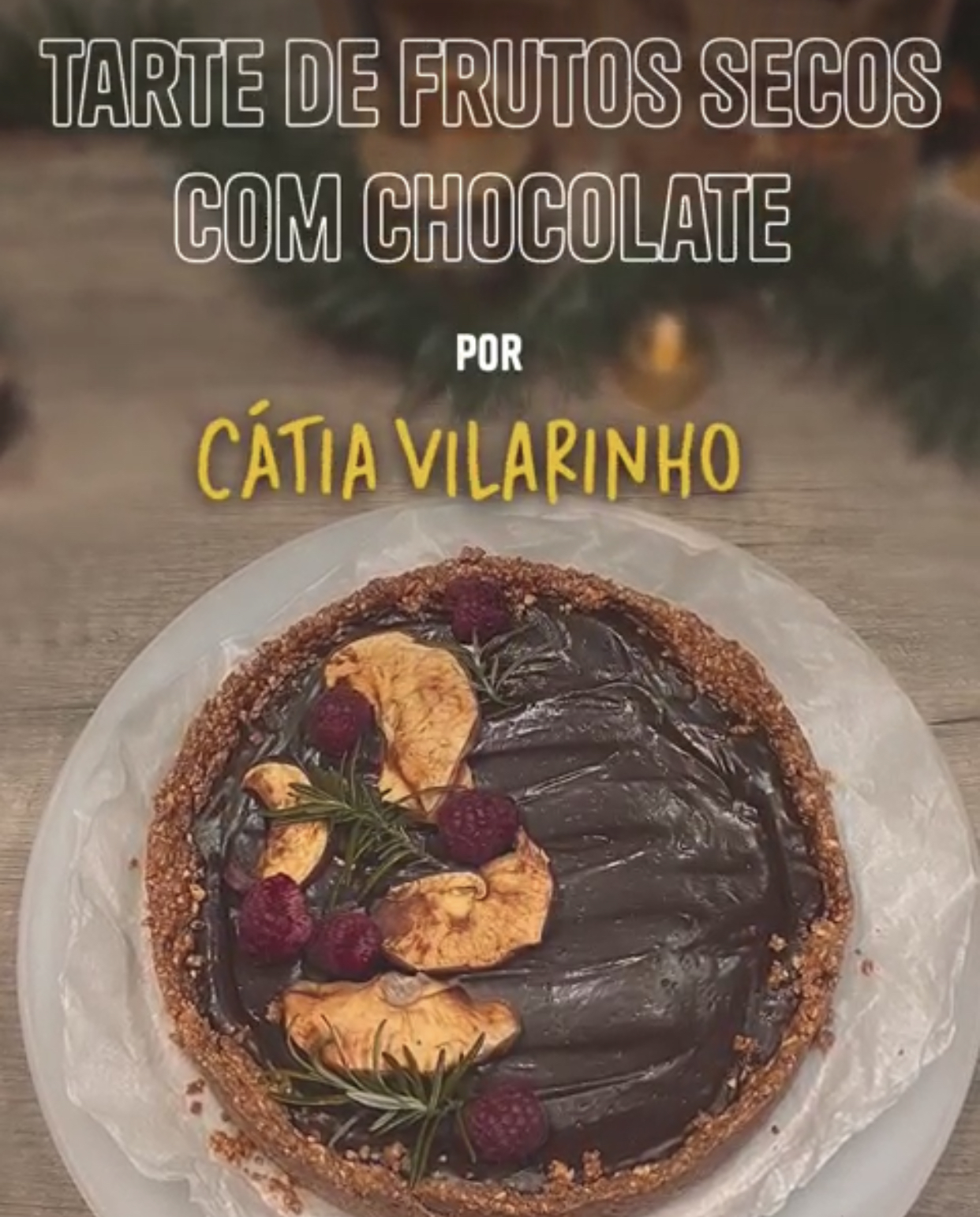 Tarte de frutos secos com chocolate num prato branco decorada com framboesas e alecrim