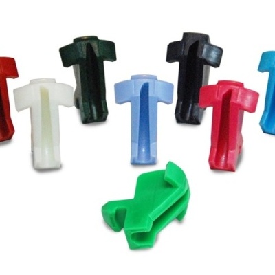 Clips plásticos coloridos em formato T sobre fundo branco