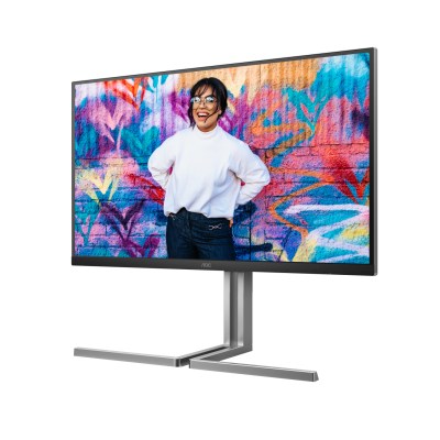 Monitor de computador exibindo uma fotografia colorida numa parede de graffiti