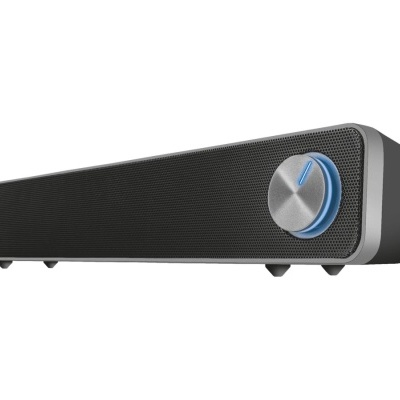 Coluna de som preta e cinzenta com botão rotativo iluminado e marca Trust.