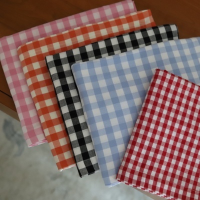 Tecidos xadrez coloridos dobrados sobre mesa de madeira