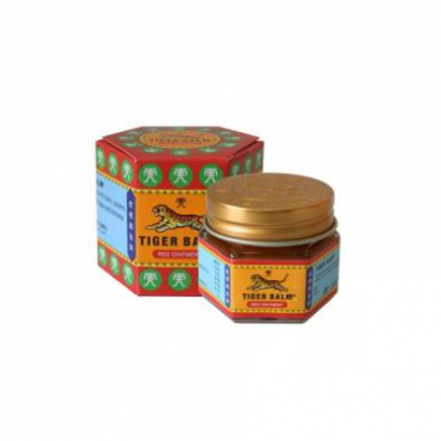 Pomada Tiger Balm em frasco de vidro com tampa dourada e caixa octogonal colorida