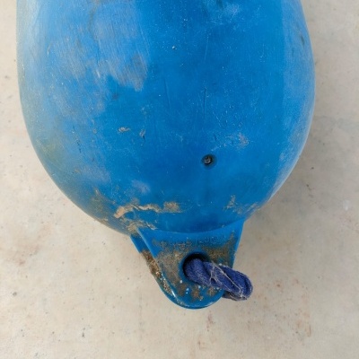 Flutuador azul com corda azul sobre superfície clara