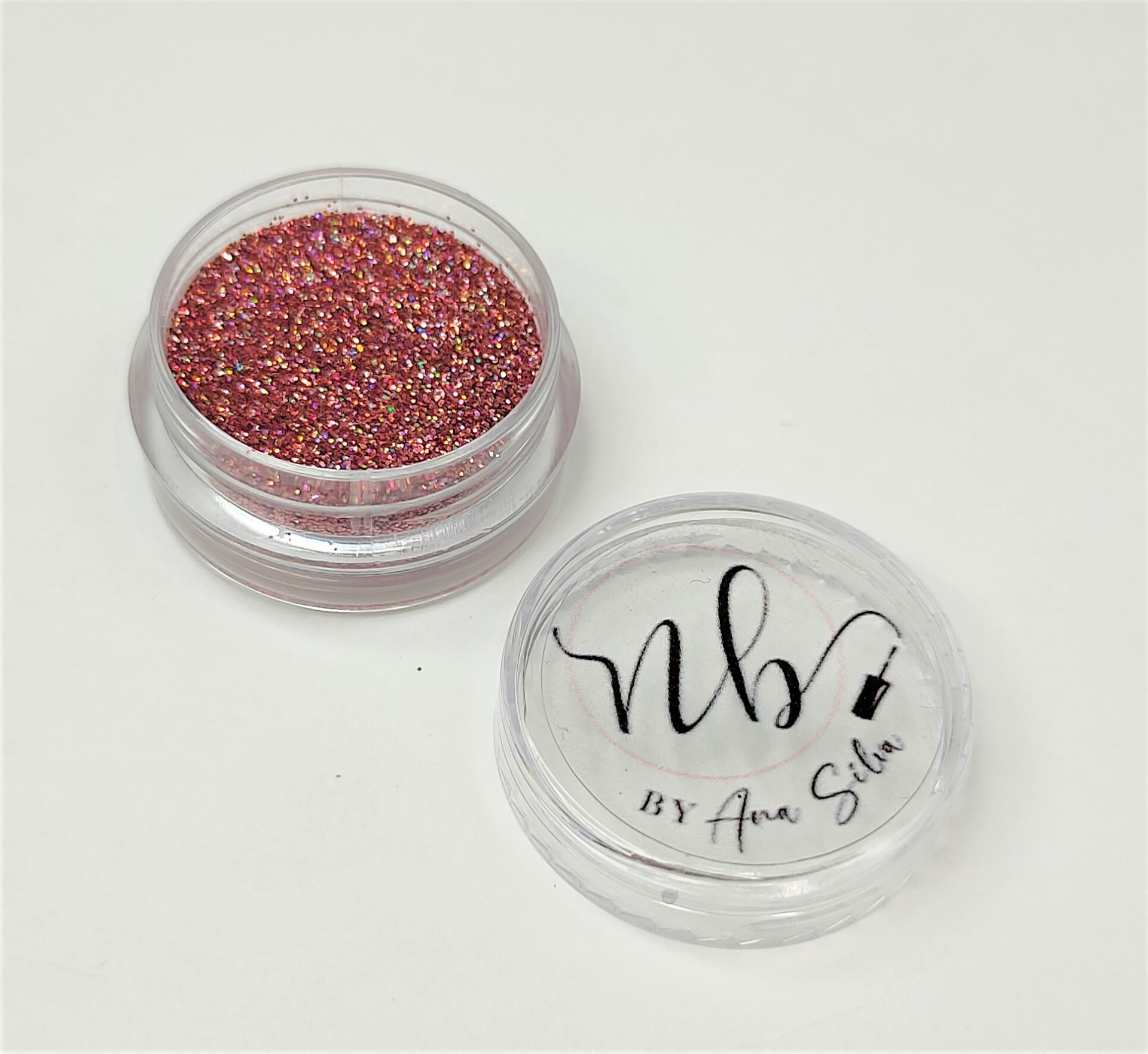 Recipiente transparente com glitter rosa e tampa com texto NBV BY Ana Silva