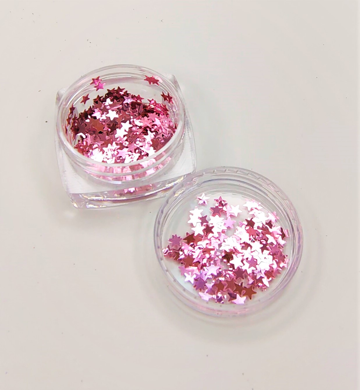 Frascos transparentes com lantejoulas rosa em forma de estrela