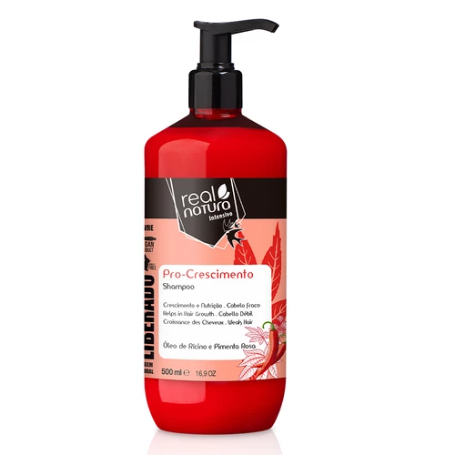 Frasco vermelho de shampoo Real Natura com doseador preto e rótulo com ilustração de folhas e pimenta rosa