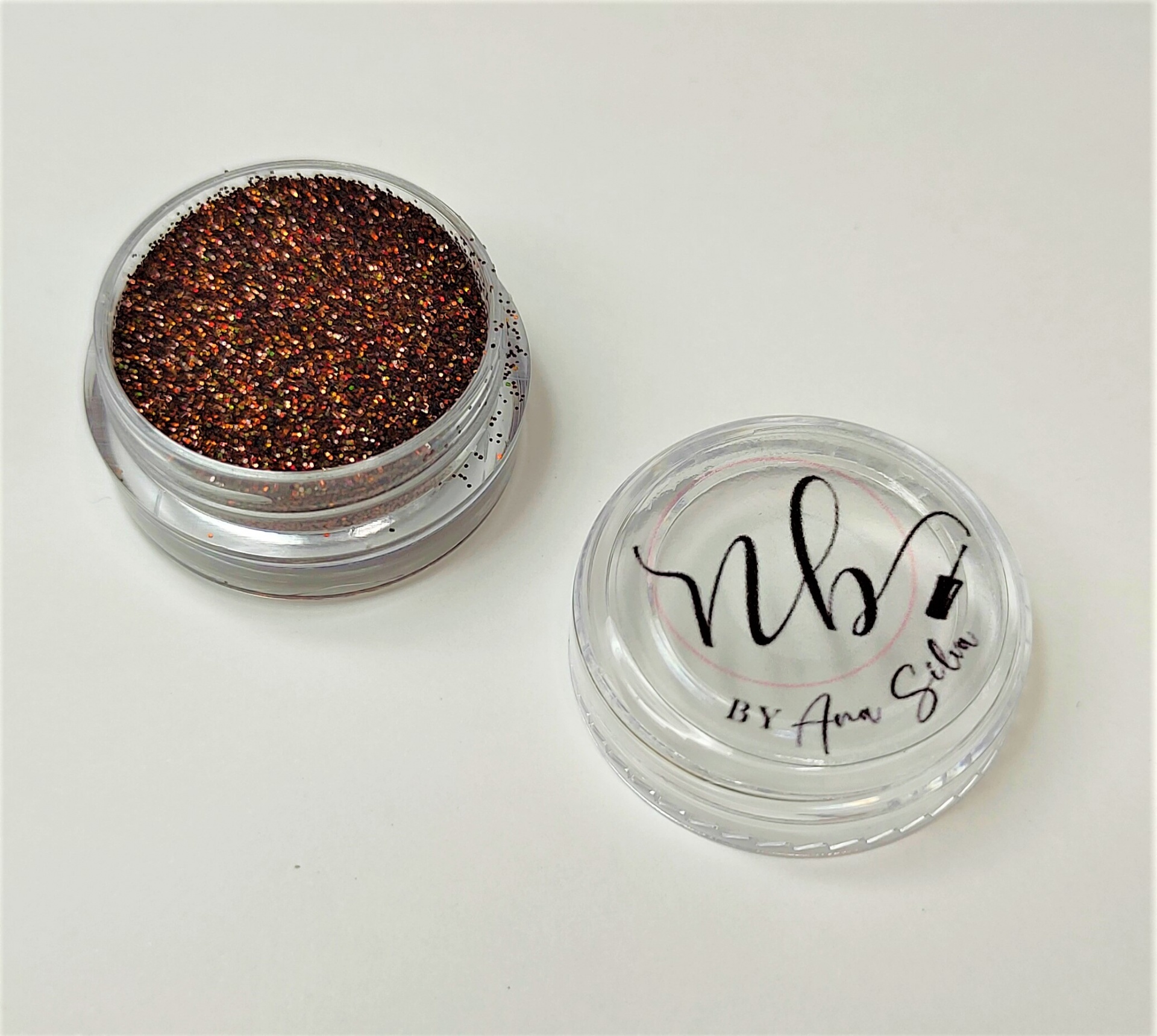 Frasco pequeno de glitter castanho-avermelhado metálico com tampa transparente e texto impresso