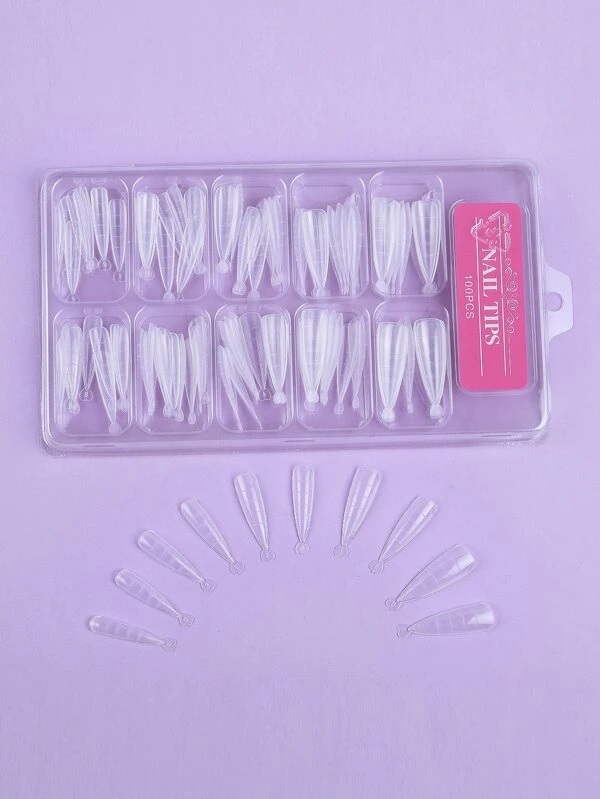 Conjunto de unhas postiças transparentes organizadas em caixa de plástico com etiqueta cor de rosa