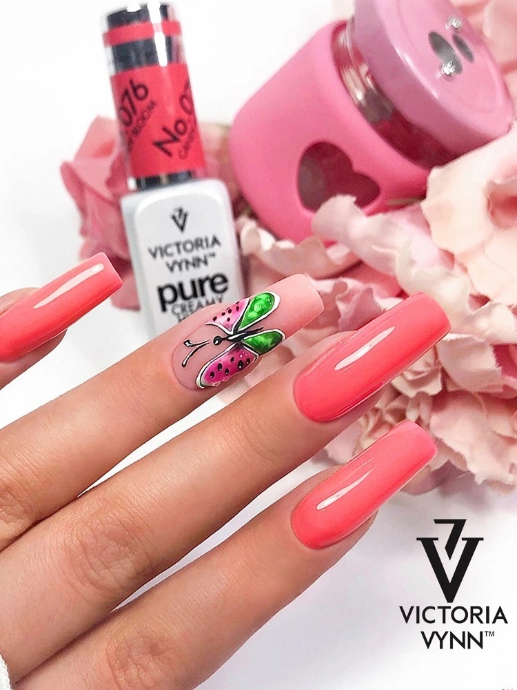 Unhas rosa coral brilhante com desenho de borboleta e frasco de esmalte Victoria Vynn