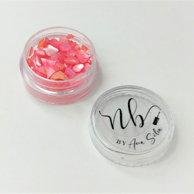 Frasco pequeno transparente com pedaços decorativos rosa e tampa com texto preto