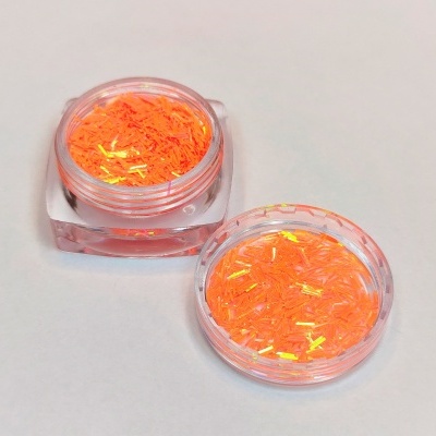 Dois frascos transparentes com glitter laranja iridescente