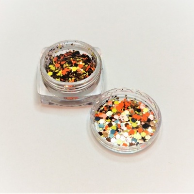 Frasco transparente com glitter colorido sobre superfície branca