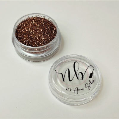 Pó solto glitter dourado em recipiente plástico com tampa transparente e texto nb! BY Ana Silva