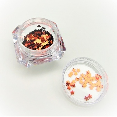 frasco acrílico transparente com lantejoulas em forma de estrelas douradas e cobre