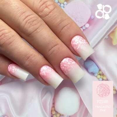 Unhas decoradas em rosa e branco com padrão de pontos