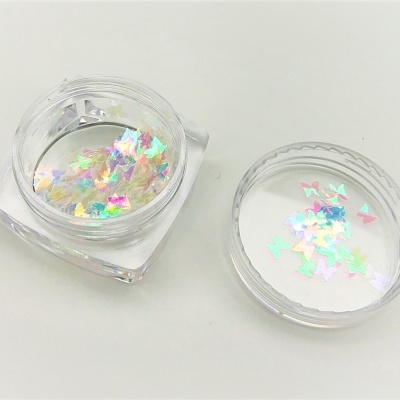 Pote transparente com flocos decorativos multicoloridos em forma de borboletas