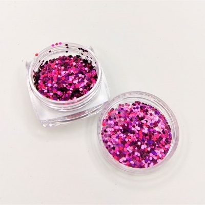 Dois frascos pequenos de glitter colorido em tons rosa e lilás