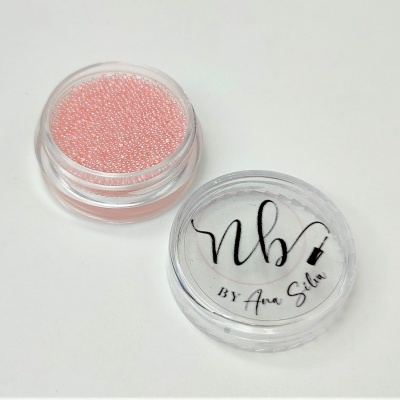 Frasco com pequenas miçangas rosa e tampa com texto NB BY Ana Silva