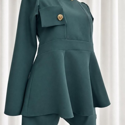 Blusa verde-escura com botão dourado e colar dourado em manequim.