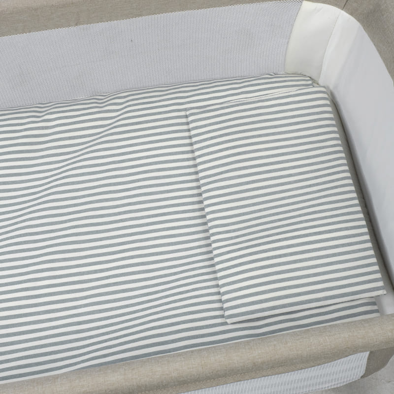 Berço com colchão e almofada de riscas cinza e branco e estrutura bege e branca