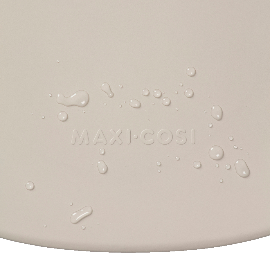 Superfície bege com gotas de água e texto MAXI-COSI em relevo