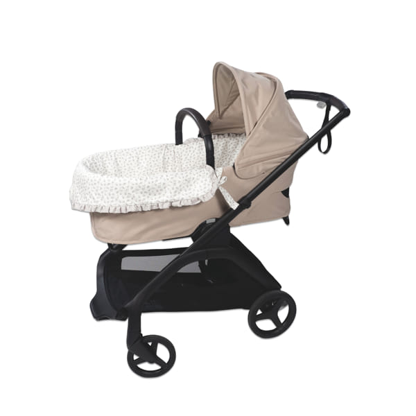 Carrinho de bebé bege e preto com interior branco e padrão pontilhado