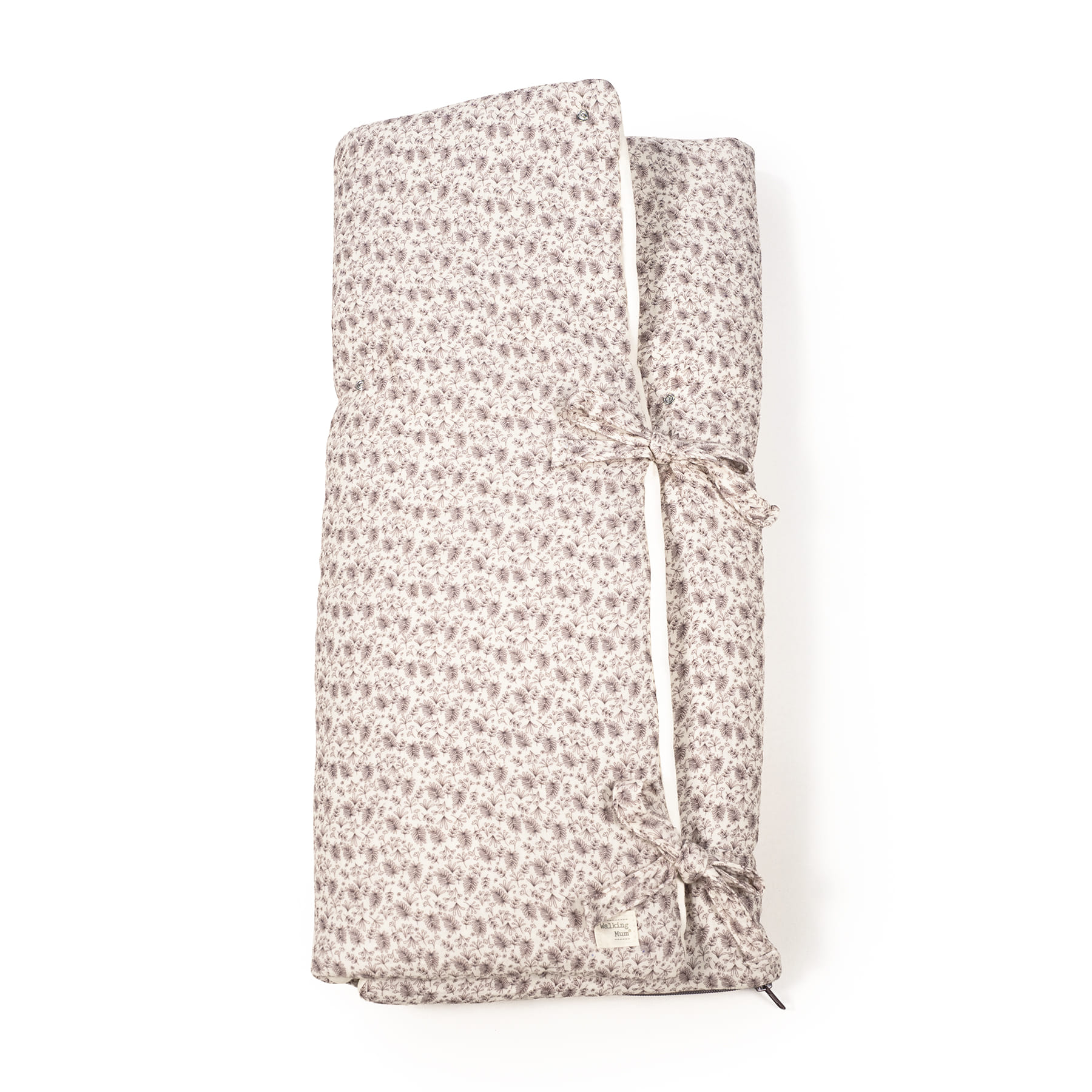 Colchão de berço com padrão floral castanho e etiqueta walking mum