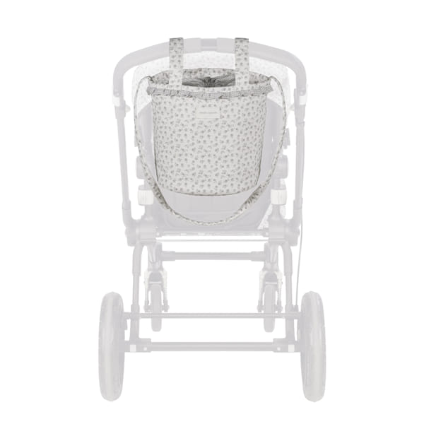 Mala de maternidade branca com padrão floral pendurada em carrinho de bebé