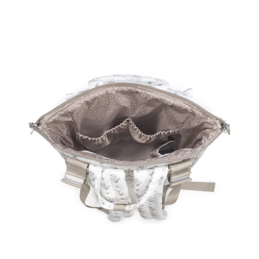 Vista superior de mala branca com padrão floral e interior castanho claro com pontos brancos