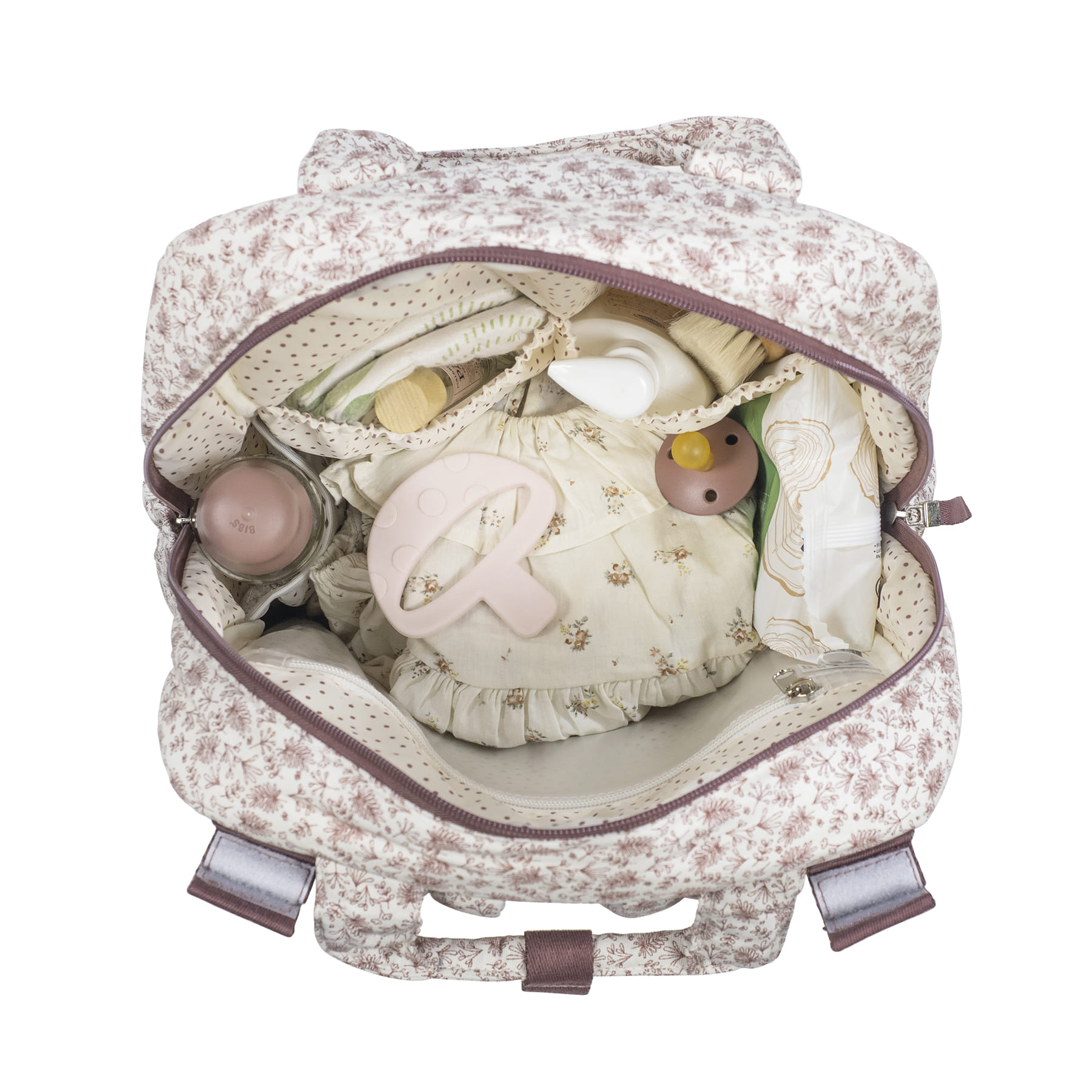 Mochila floral aberta mostrando itens de bebé organizados dentro.