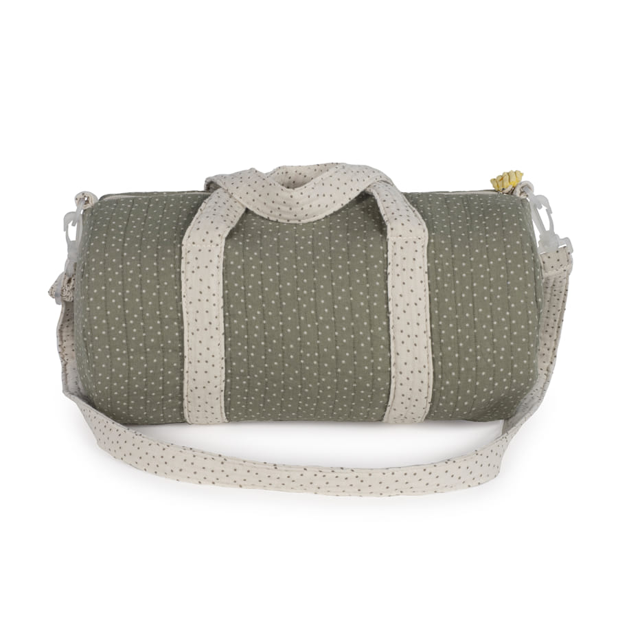 Mala de viagem tipo saco verde com alças creme e bolinhas.