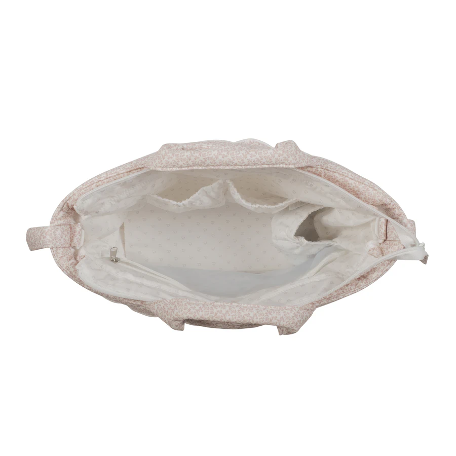 Bolsa de tecido floral rosa vista de cima com interior branco e vários compartimentos
