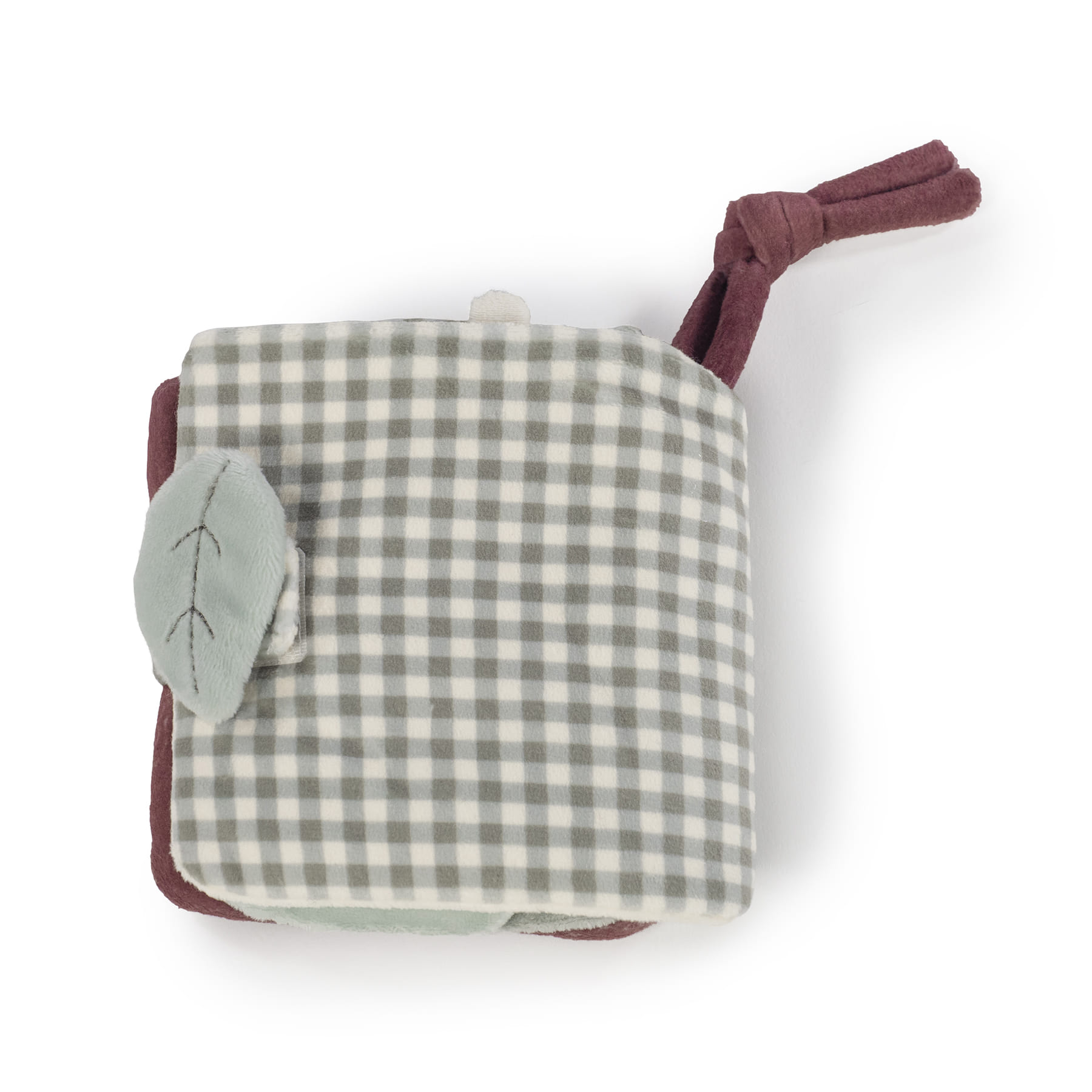 Livro infantil tátil de tecido com padrão xadrez cinza e branco e detalhe de folha verde.