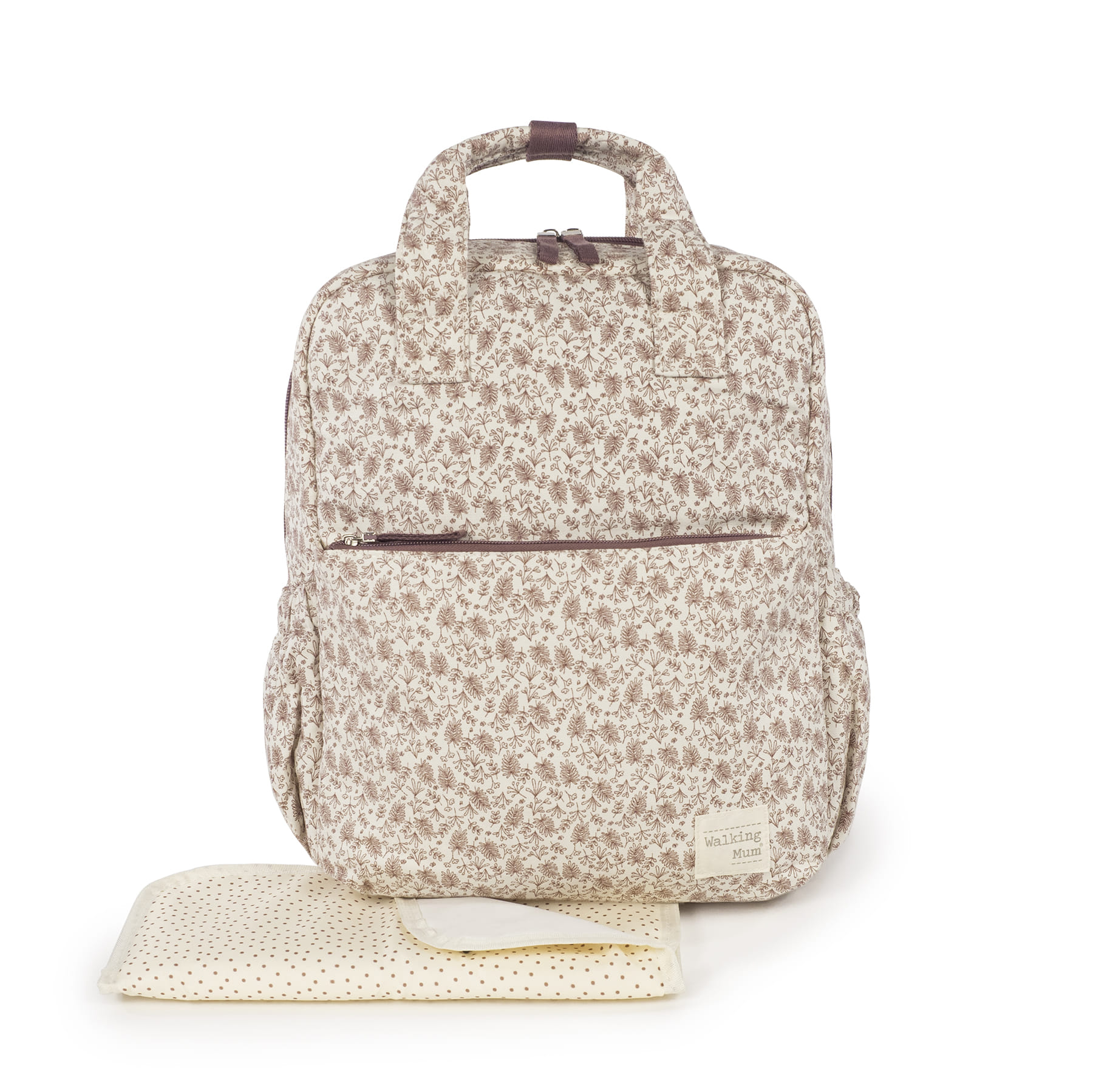 Mochila bege com padrão floral castanho e trocador creme com bolinhas castanhas