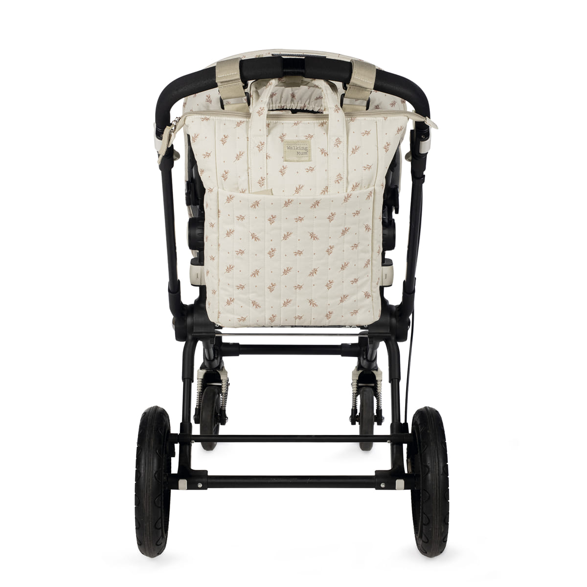 Carrinho de bebê preto com tecido bege e padrão floral
