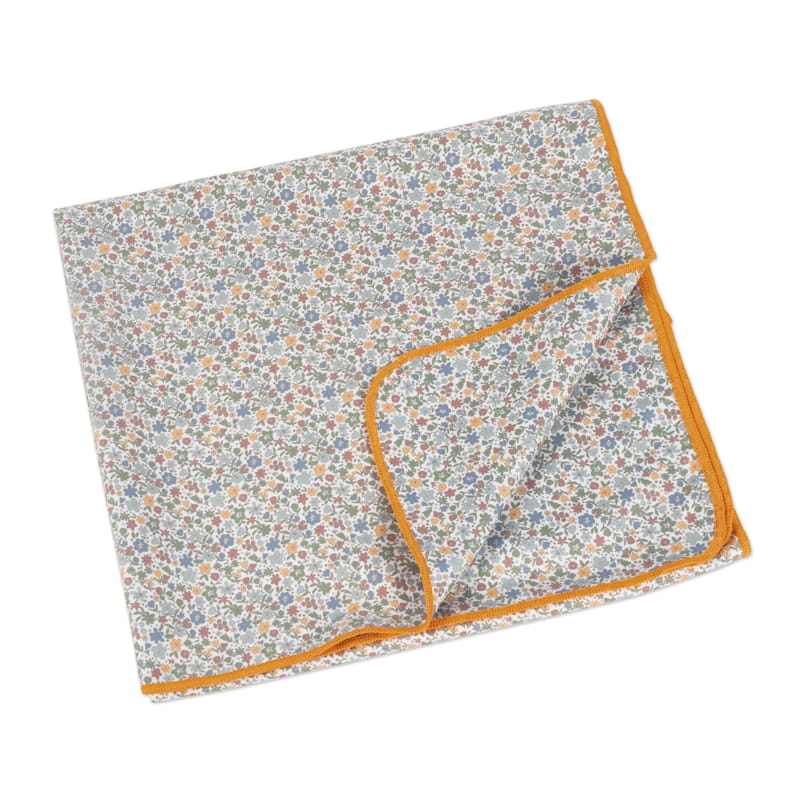Manta com padrão floral e rebordo laranja