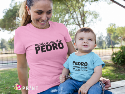 Mulher com t-shirt rosa e bebé com t-shirt azul claro sentados em banco de madeira ao ar livre.