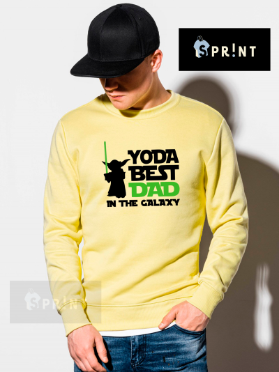 Homem de boné preto a usar sweatshirt amarela com estampa Yoda BEST DAD IN THE GALAXY.