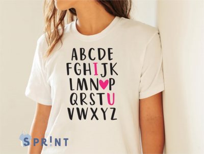 T-shirt branca com letras pretas do alfabeto e detalhes cor-de-rosa