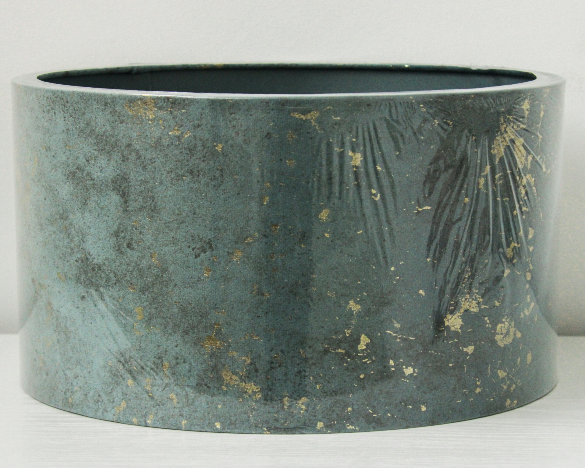 Vaso cilíndrico azul esverdeado com detalhes dourados e padrão de folhas em relevo